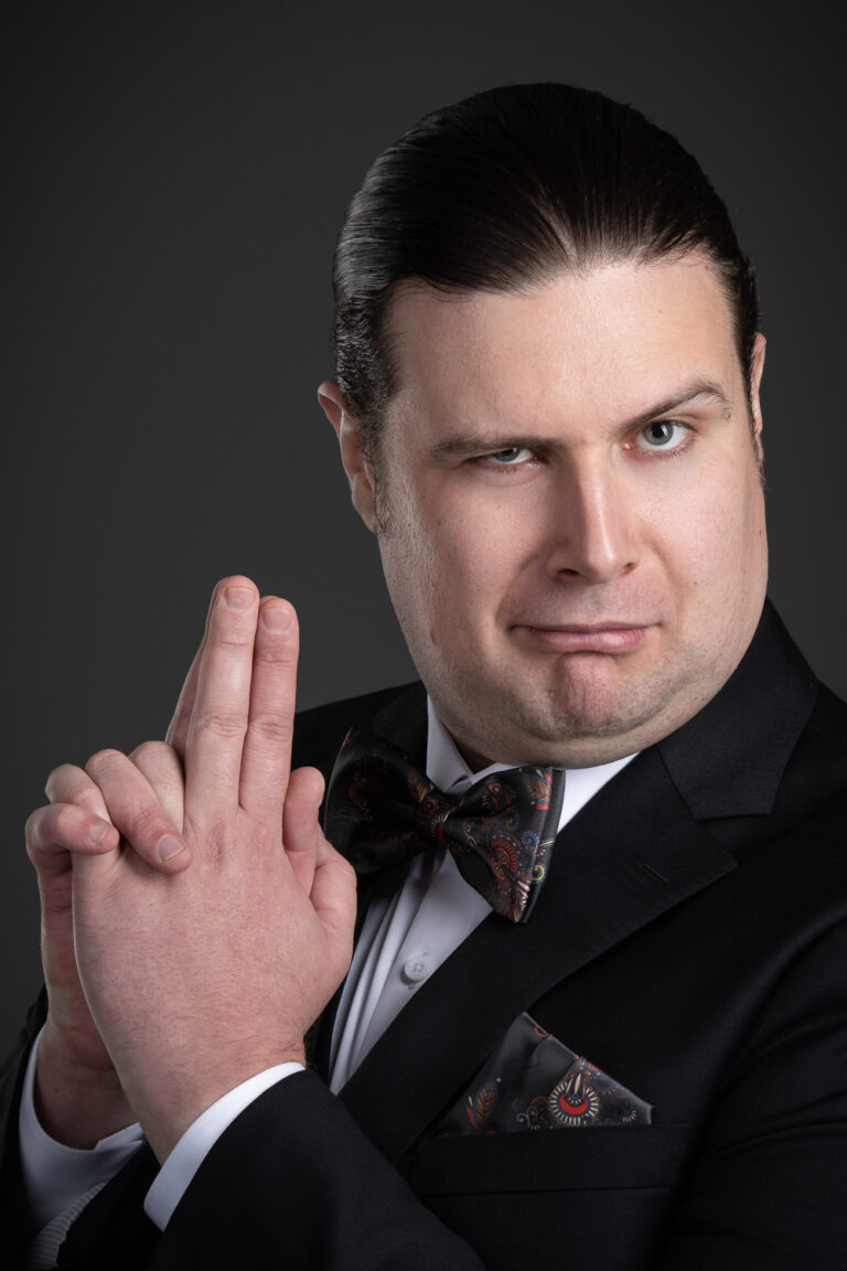 Playful headshot of Adelaide actor John in a bow-tie