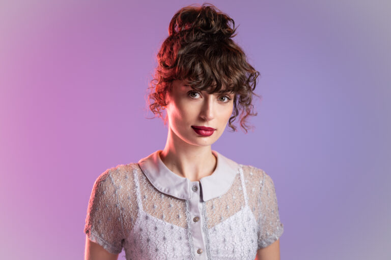 Adelaide Actor Emma Batten on a blue background
